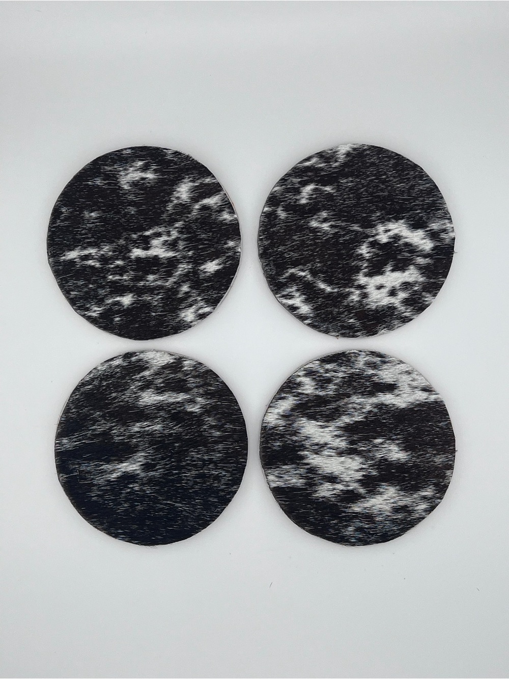 Set of 4 Round Black & White Cowhide Coasters